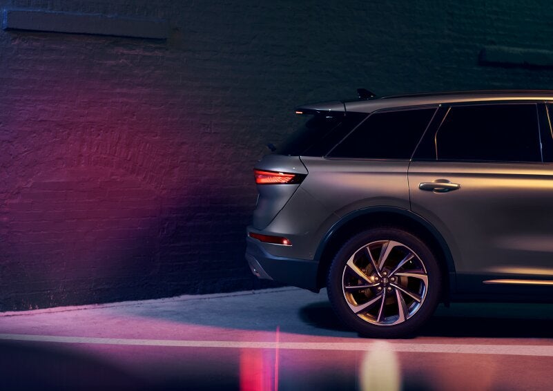 A dramatization of a 2025 Lincoln Corsair® SUV is shown backing up toward a wall. | Friendly Lincoln in Monroe MI