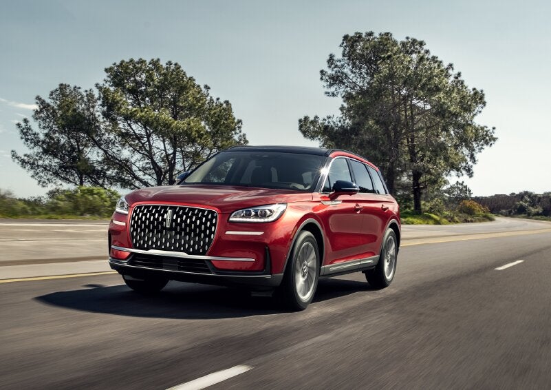 A 2025 Lincoln Corsair® SUV is shown being driven on a country road. | Friendly Lincoln in Monroe MI