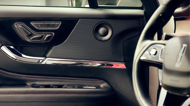 A Revel® audio speaker is shown in the driver's side door of a 2025 Lincoln Corsair® SUV. | Friendly Lincoln in Monroe MI