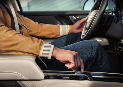 The driver of a 2024 Lincoln Corsair® SUV is shown selecting the drive mode. | Friendly Lincoln in Monroe MI