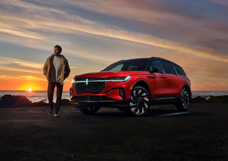 A person is shown next to a 2025 Lincoln Nautilus® SUV as the Lincoln Embrace sequence takes place. | Friendly Lincoln in Monroe MI