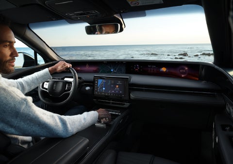 A driver of a parked 2025 Lincoln Nautilus® SUV takes a relaxing moment at a seaside overlook while inside his Nautilus. | Friendly Lincoln in Monroe MI