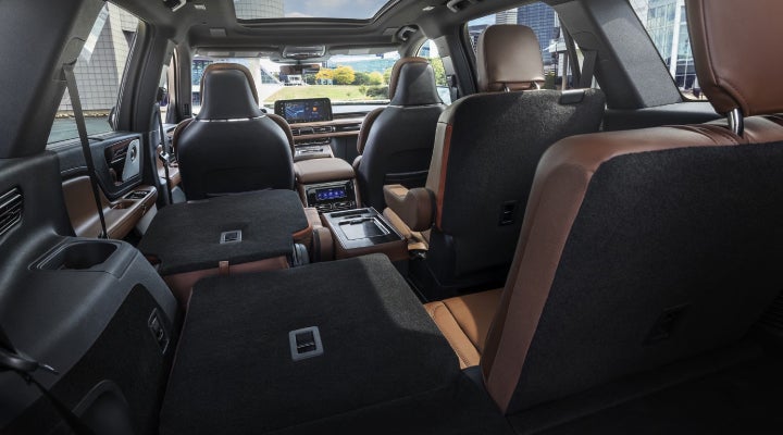 One side of the PowerFold® third-row seat and a second-row seat are folded forward in the 2026 Lincoln Aviator® SUV. | Friendly Lincoln in Monroe MI