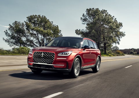 A 2026 Lincoln Corsair® SUV is shown being driven on a country road. | Friendly Lincoln in Monroe MI