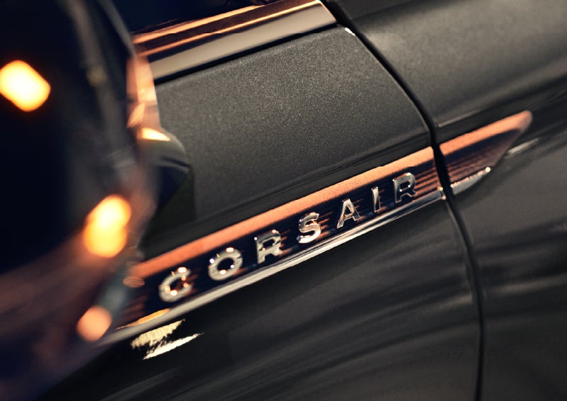 A 2026 Lincoln Corsair® SUV is shown being driven on a country road. | Friendly Lincoln in Monroe MI