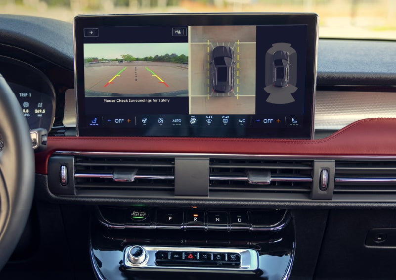 A couple approaches a 2026 Lincoln Corsair® Reserve model as the Lincoln Embrace illumination guides the way | Friendly Lincoln in Monroe MI