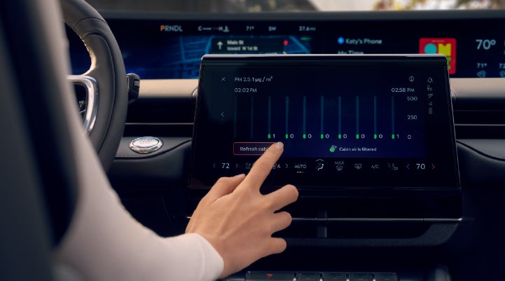 A woman is shown using the Auto Air Refresh feature in the 2026 Lincoln Nautilus® SUV. | Friendly Lincoln in Monroe MI