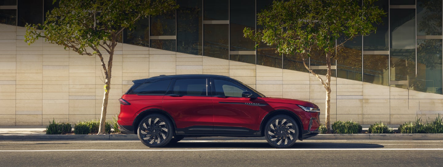 A 2026 Lincoln Nautilus® SUV with an available Hybrid Powertrain is parked in an urban setting. | Friendly Lincoln in Monroe MI