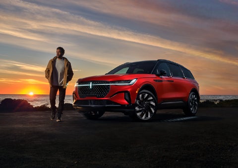 A person is shown next to a 2026 Lincoln Nautilus® SUV as the Lincoln Embrace sequence takes place. | Friendly Lincoln in Monroe MI