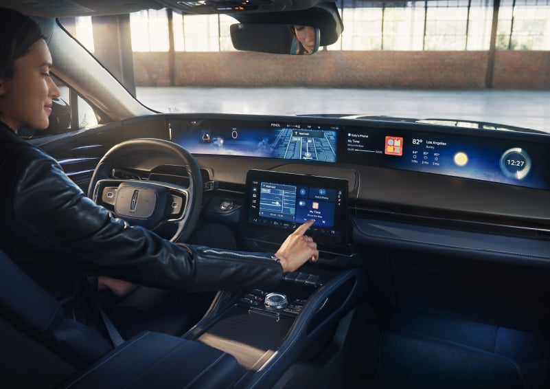 The driver of a 2026 Lincoln Nautilus® SUV interacts with the center touchscreen. | Friendly Lincoln in Monroe MI