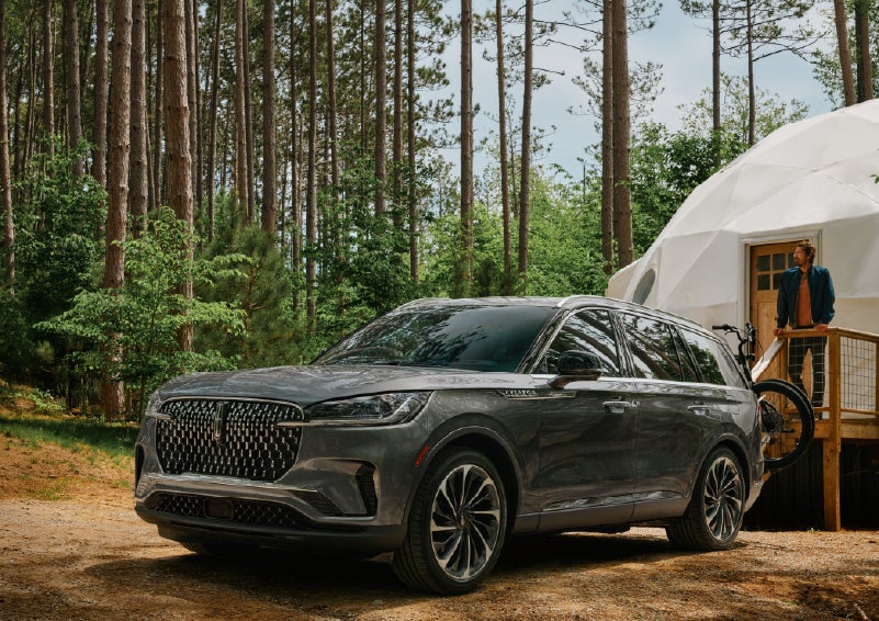 A 2027 Lincoln Aviator® is parked next to a high end glamping site. | Friendly Lincoln in Monroe MI