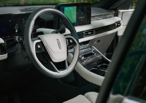The leather-trimmed steering wheel of a 2027 Lincoln Aviator® Black Label™ SUV. | Friendly Lincoln in Monroe MI