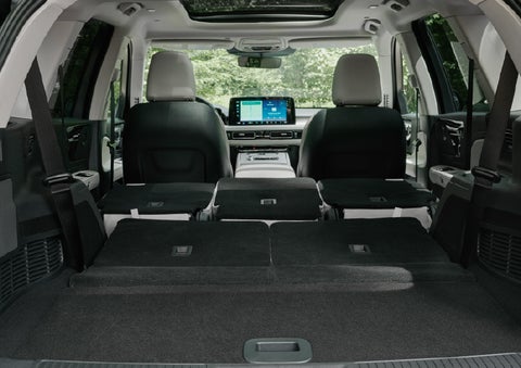 A rear to front view of the interior of a 2027 Lincoln Aviator® Black Label™ SUV shows the third and second rows folded flat | Friendly Lincoln in Monroe MI