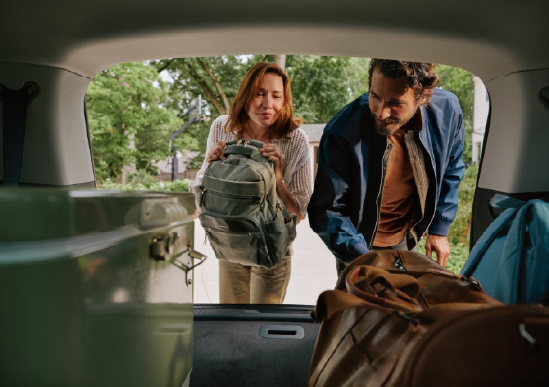 A couple loads luggage into the rear of a 2027 Lincoln Aviator® Black Label™ SUV..e 202 | Friendly Lincoln in Monroe MI