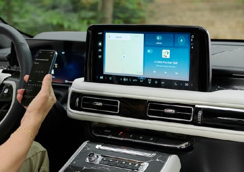 A person pairs thier phone with the center touchscreen of a 2027 Lincoln Aviator® Black Label™ SUV | Friendly Lincoln in Monroe MI