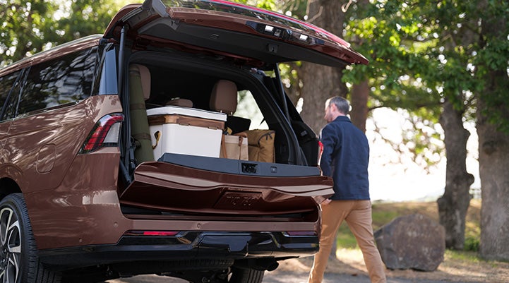 The Lincoln Split Gate of a 2027 Lincoln Navigator® SUV is open, revealing cargo in the rear.