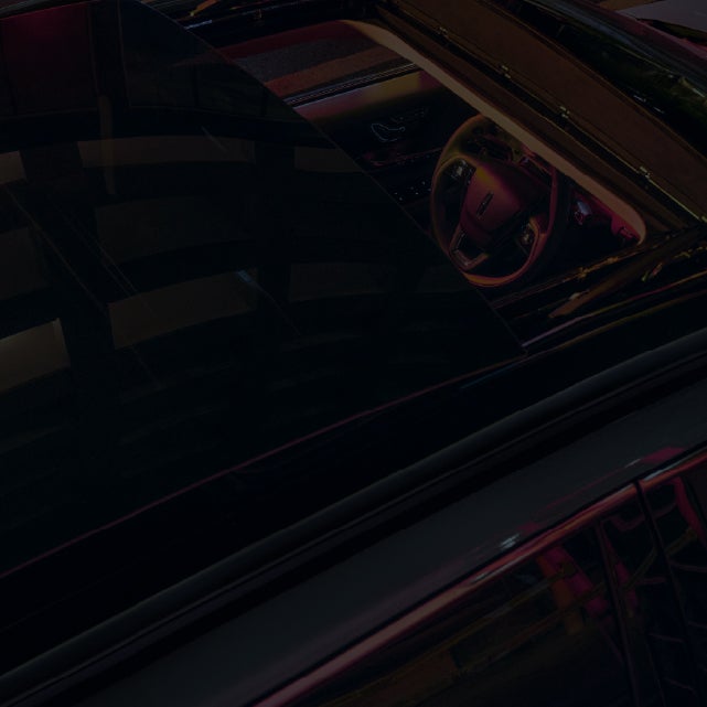 A close-up of the top of a 2026 Lincoln Corsair® Grand Touring SUV and interior seen through the panoramic Vista Roof®.